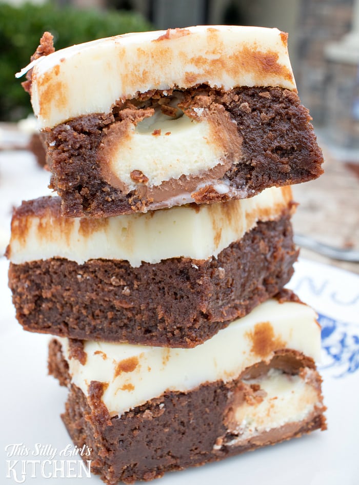 White Chocolate Truffle Stuffed Brownies, irresistible fudgy brownies stuffed with truffles and topped with a thick layer of white chocolate ganache, a chocolate lover's dream! from ThisSillyGirlsLife.com #stuffedbrownies 