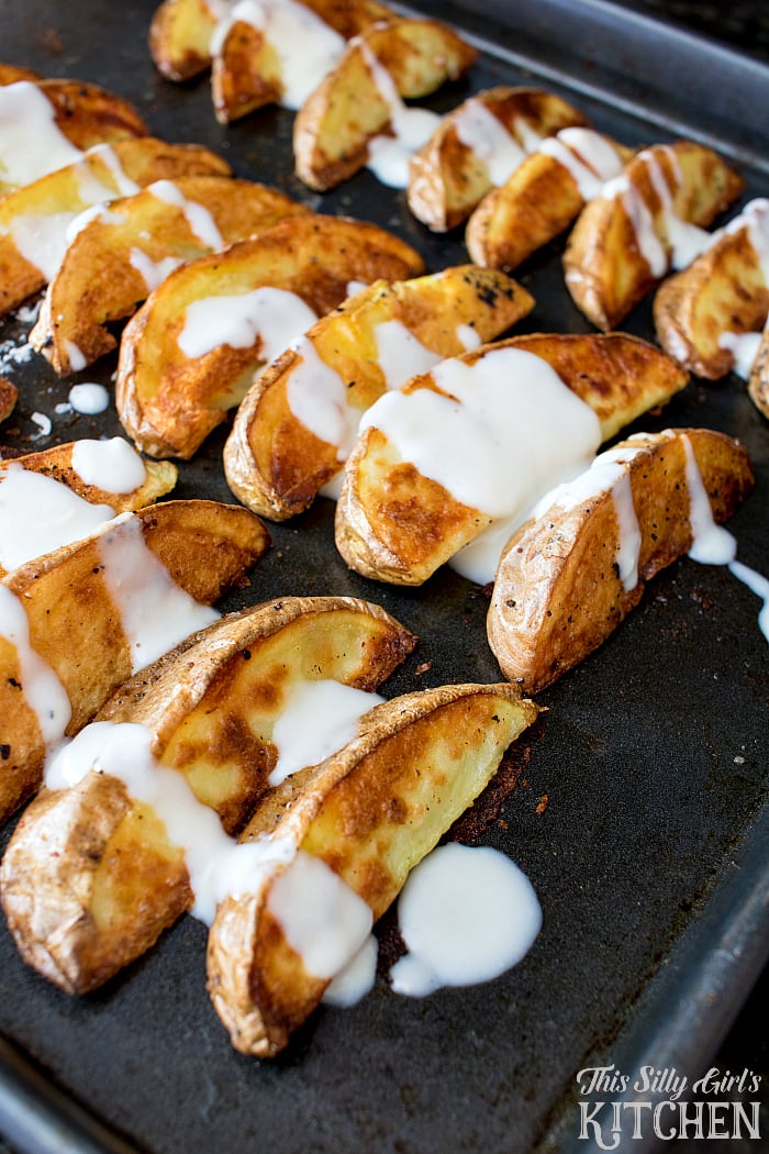 Garlic Parmesan Roasted Potato Wedges, oven roasted potatoes drizzled with garlic Parmesan sauce! from ThisSillyGirlsLife.com #ad