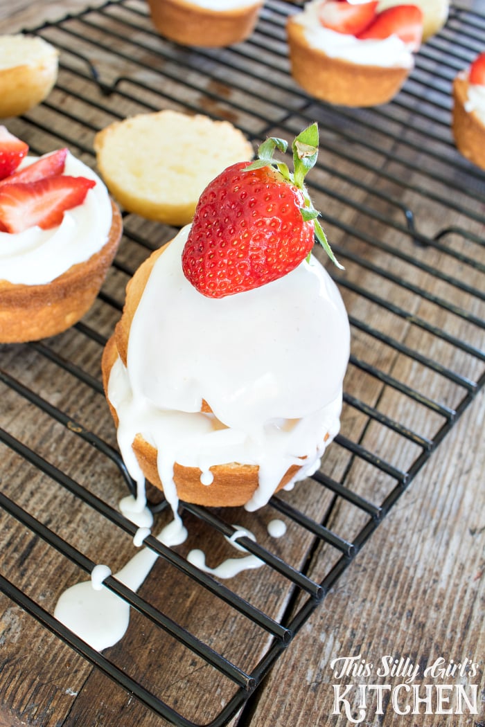 Strawberry Shortcake Cupcakes, white cake sliced in half, stuffed with vanilla frosting and fresh strawberries, drizzled with a vanilla frosting glaze! from ThisSillyGirlsLife.com #ad