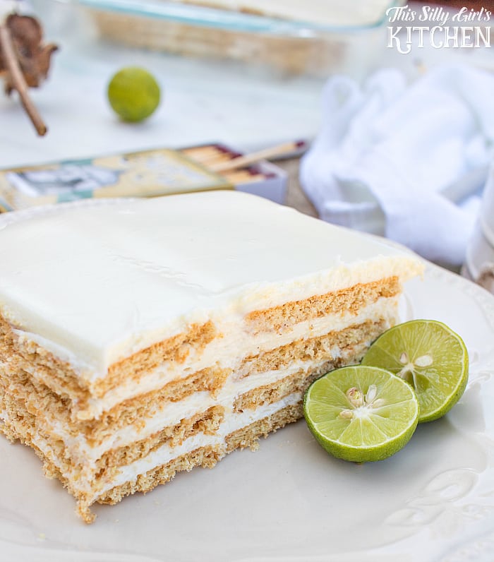 Key Lime Eclair Cake, layers of creamy filling bursting with key lime flavor between graham crackers, topped with vanilla frosting. Tastes just like a key lime pie, but much easier! from ThisSillyGirlsLife.com #keylimepie #eclaircake