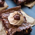 Mocha Brownies square topped with a swirl of coffee frosting and a chocolate candy.