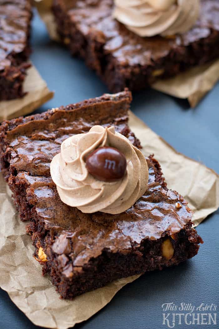 Mocha Brownies square topped with a swirl of coffee frosting and a chocolate candy.