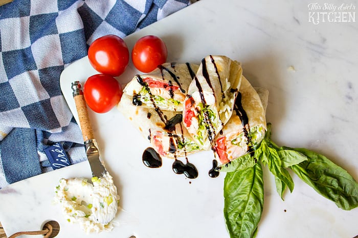 Caprese Chicken Wraps, grilled chicken, mozzarella, basil and tomatoes wrapped in a warm flour tortilla and drizzled with balsamic glaze. from ThisSillyGirlsLife.com #SummerGoodness #ad