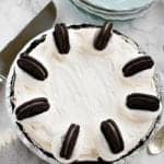 A whole no bake Oreo pie topped with a ring of Oreo cookies in a chocolate cookie crust.
