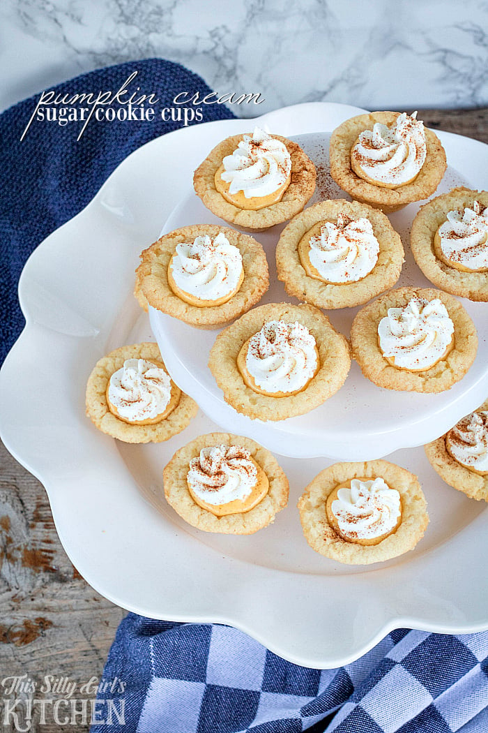 Pumpkin Cream Sugar Cookie Cups, sweetened cream cheese flavored with pumpkin and cinnamon in sugar cookie cups, garnished with fresh whipped cream! from ThisSillyGirlsLife.com