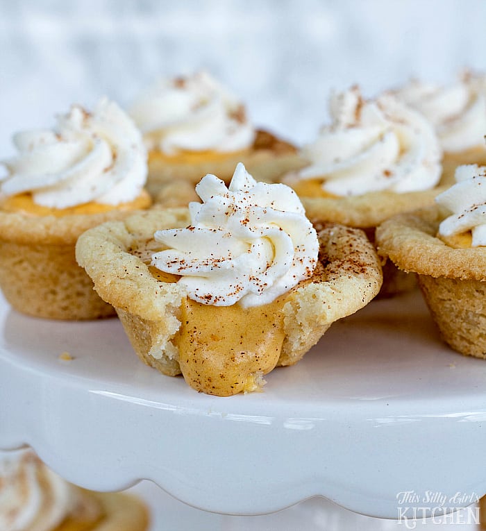 Pumpkin Cream Sugar Cookie Cups, sweetened cream cheese flavored with pumpkin and cinnamon in sugar cookie cups, garnished with fresh whipped cream! from ThisSillyGirlsLife.com
