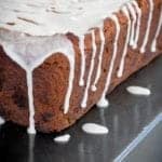 Cream Cheese Banana Bread loaf covered in vanilla glaze dripping down the sides.