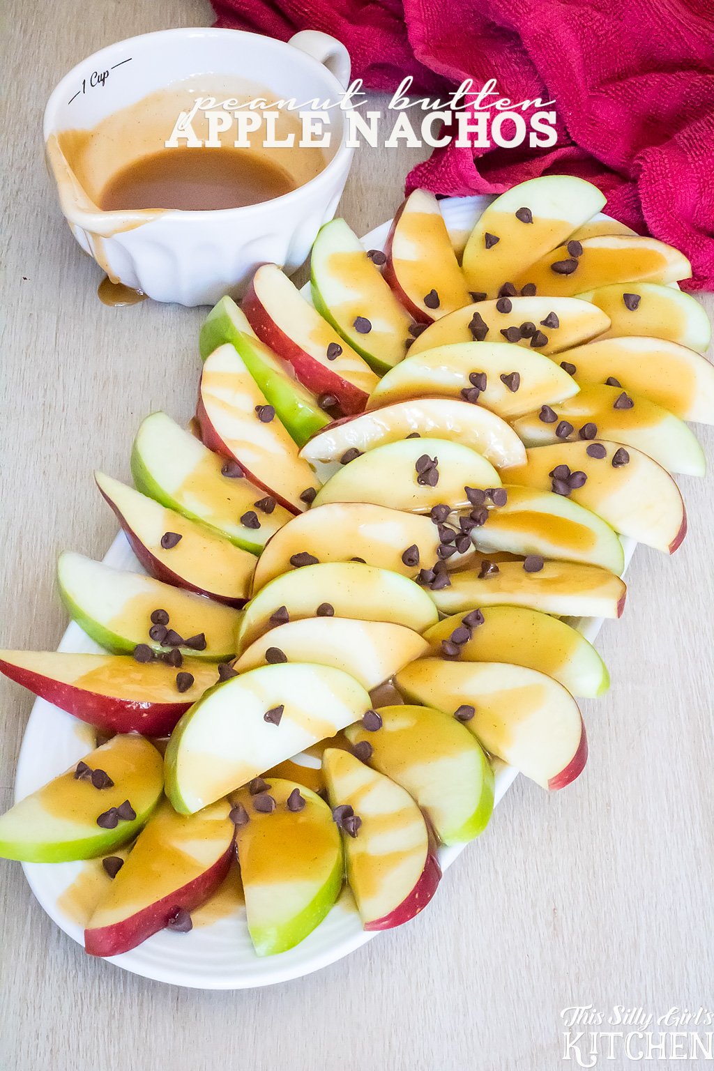 Peanut Butter Apple Nachos, a fun fall snack! Peanut butter sauce is drizzled over apple slices and garnished with mini chocolate chips. from ThisSillyGirlsKitchen.com #ad