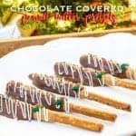 Chocolate covered peanut butter pretzels with white chocolate drizzle and sprinkles standing in a jar.