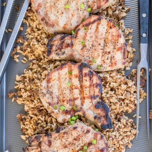 Juicy brown sugar brined grilled pork chops served over seasoned rice with scallions.