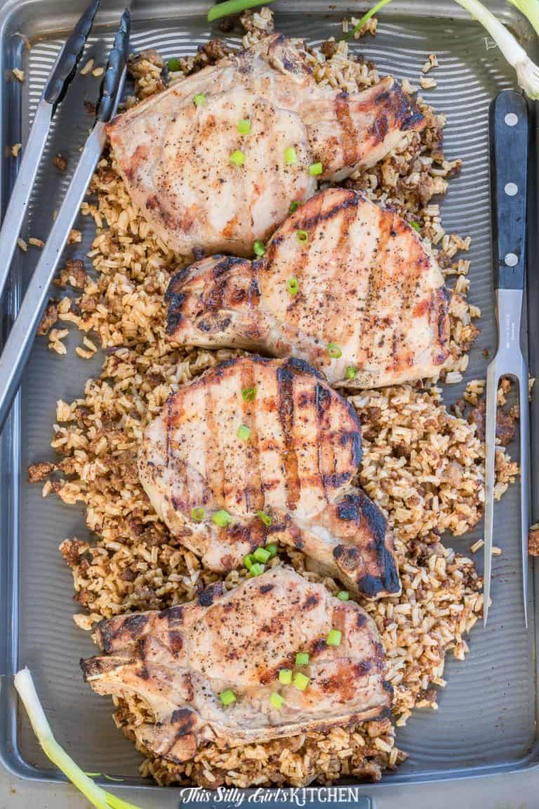 Juicy brown sugar brined grilled pork chops served over seasoned rice with scallions.