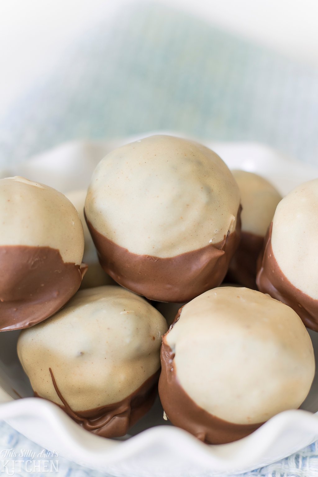 Close up of Peanut Butter Oreo Buckeyes stacked in white bowl