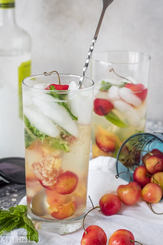 Rainier Cherry Mojitos, Fresh Rainier Cherries muddled with mint leaves, mixed with rum and fizzy soda! Recipe from ThisSillyGirlsKitchen.com