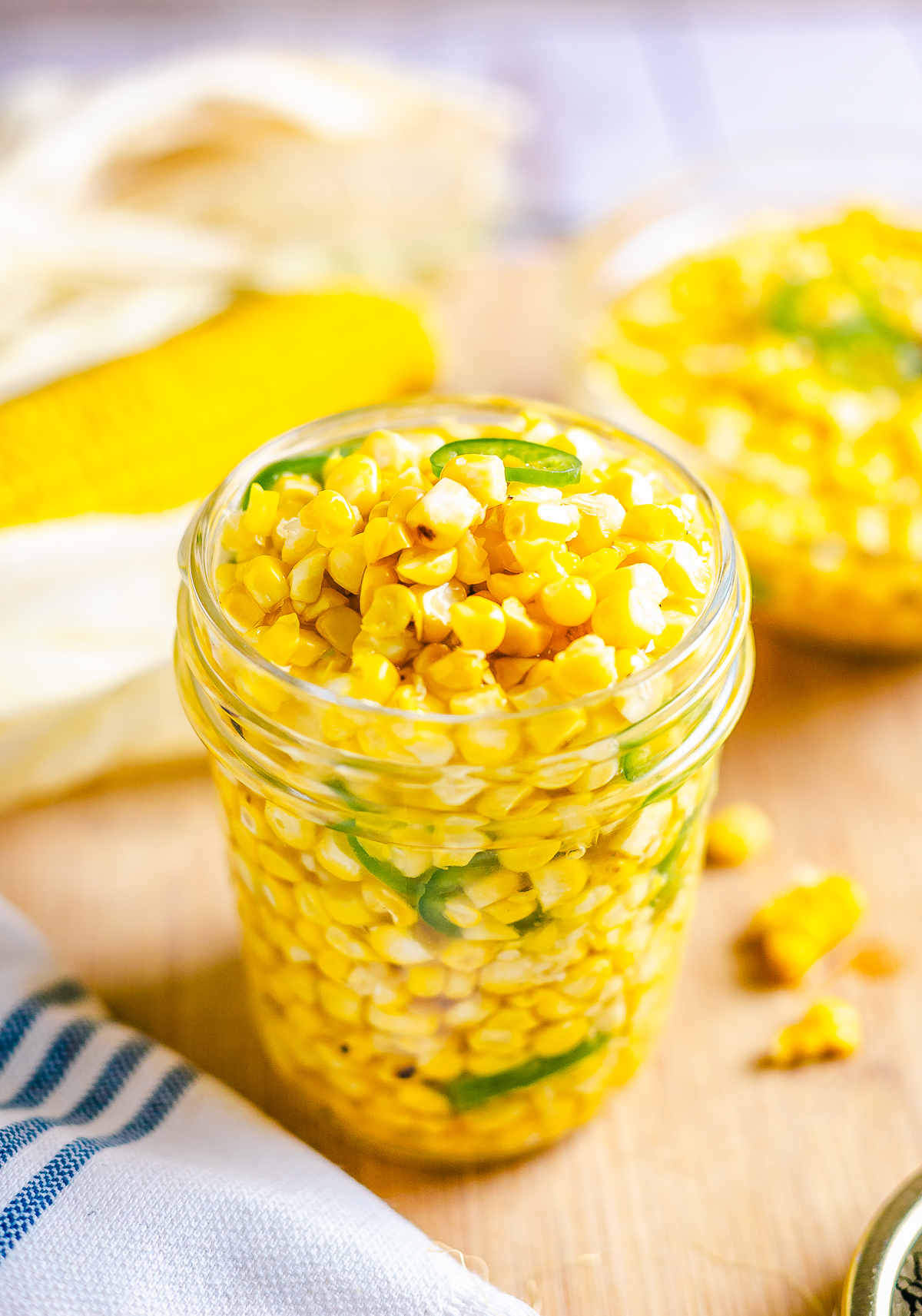Corn Relish in mason jar with corn in background