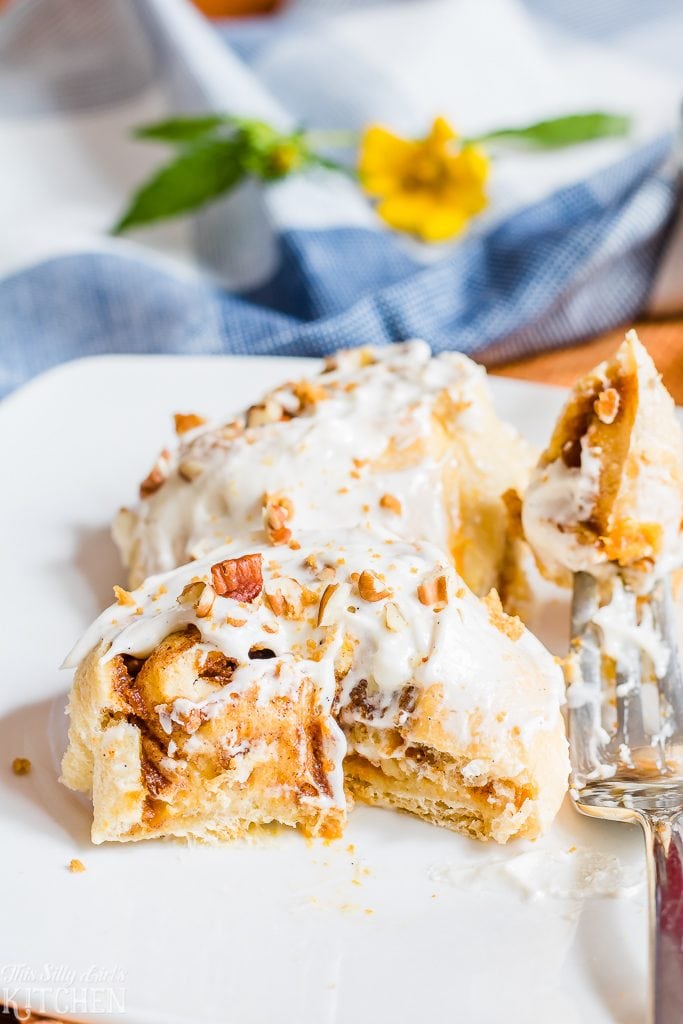 Pumpkin Cinnamon Rolls in just 30 minutes with crunchy pecans and a sweet marshmallow glaze!  Recipe from ThisSillyGirlsKitchen.com