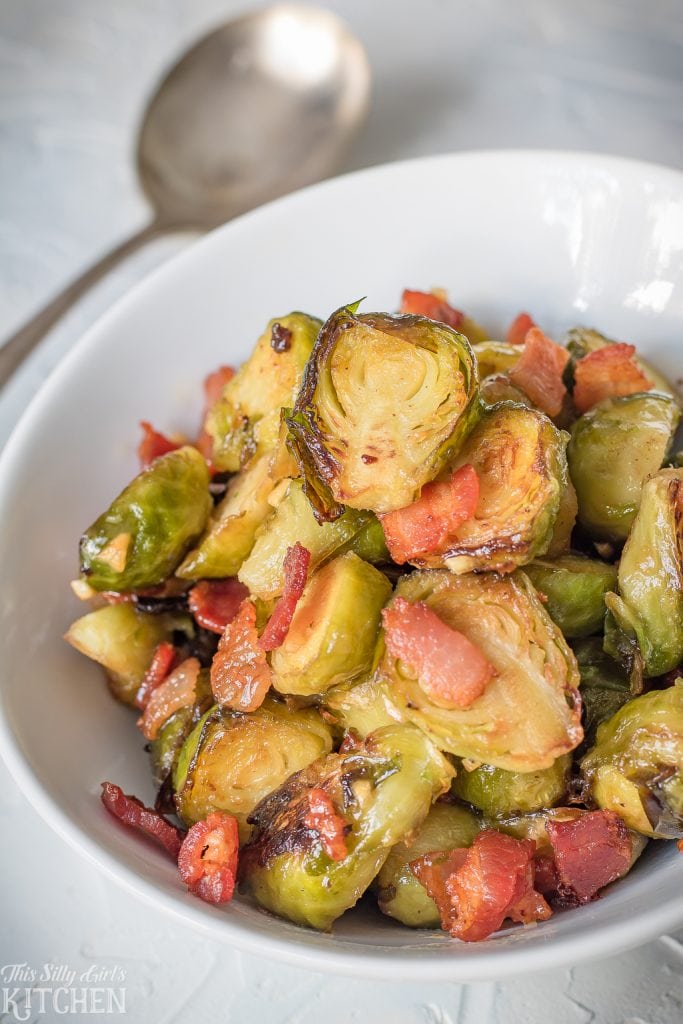 Roasted Brussel Sprouts with Bacon in white dish with spoon