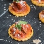 Brisket ragu spooned over crispy polenta cakes topped with shaved Parmigiano Reggiano and fresh basil.