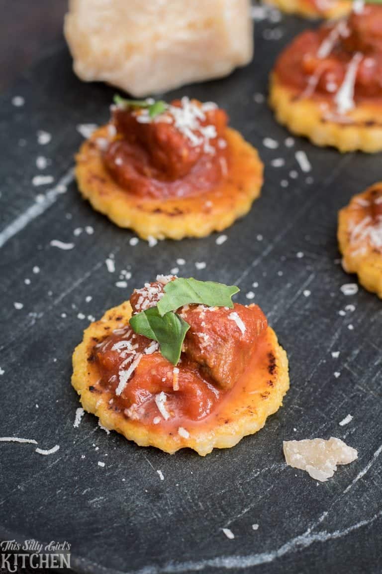 Brisket ragu spooned over crispy polenta cakes topped with shaved Parmigiano Reggiano and fresh basil.