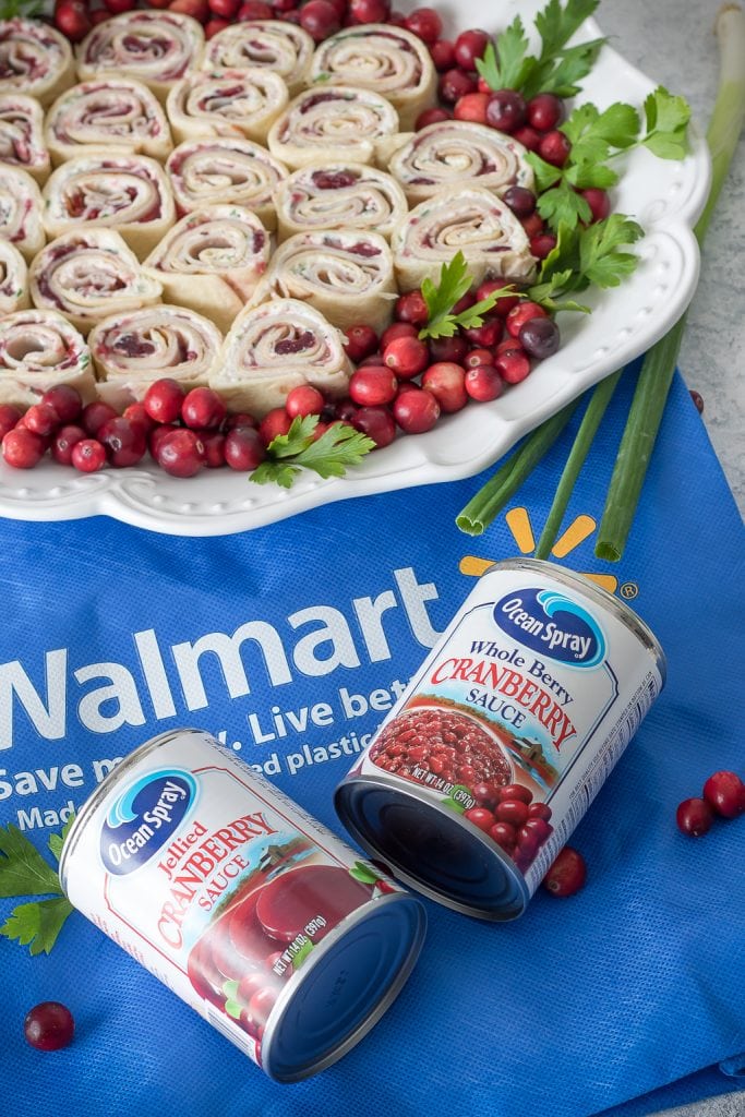 Cranberry Turkey Pinwheels on tray with two cans of cranberry sauce in front