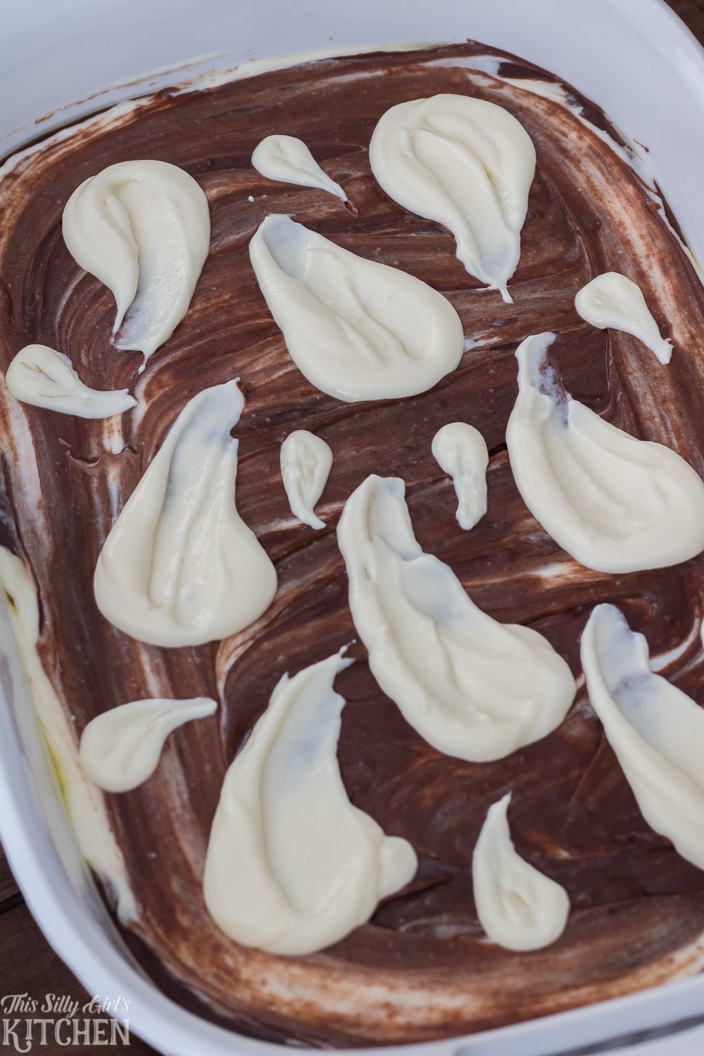 Cheesecake filling swirled into ghost shapes over brownie batter.