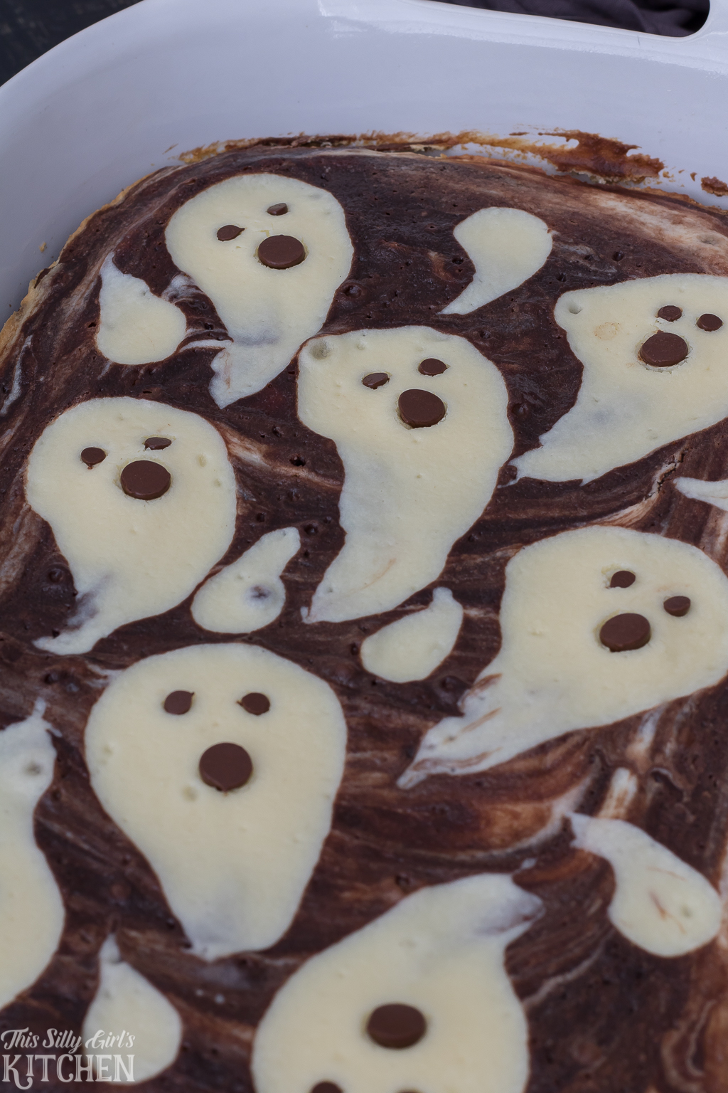 Finished close up Ghost Cheesecake Brownies in baking pan.