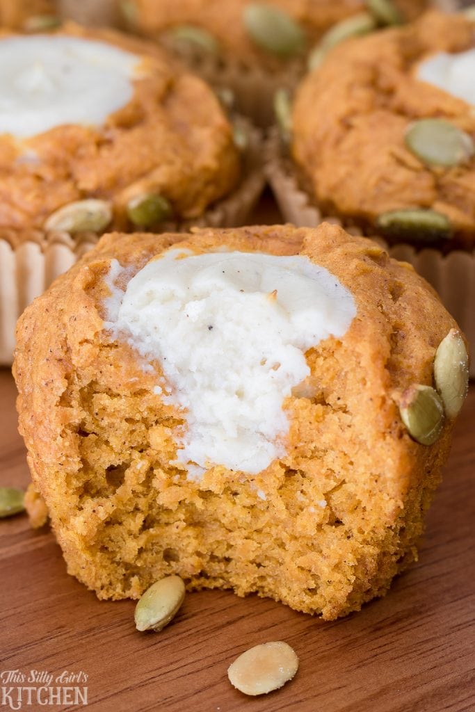 Pumpkin Cream Cheese Muffin with bite taken out showing inside.