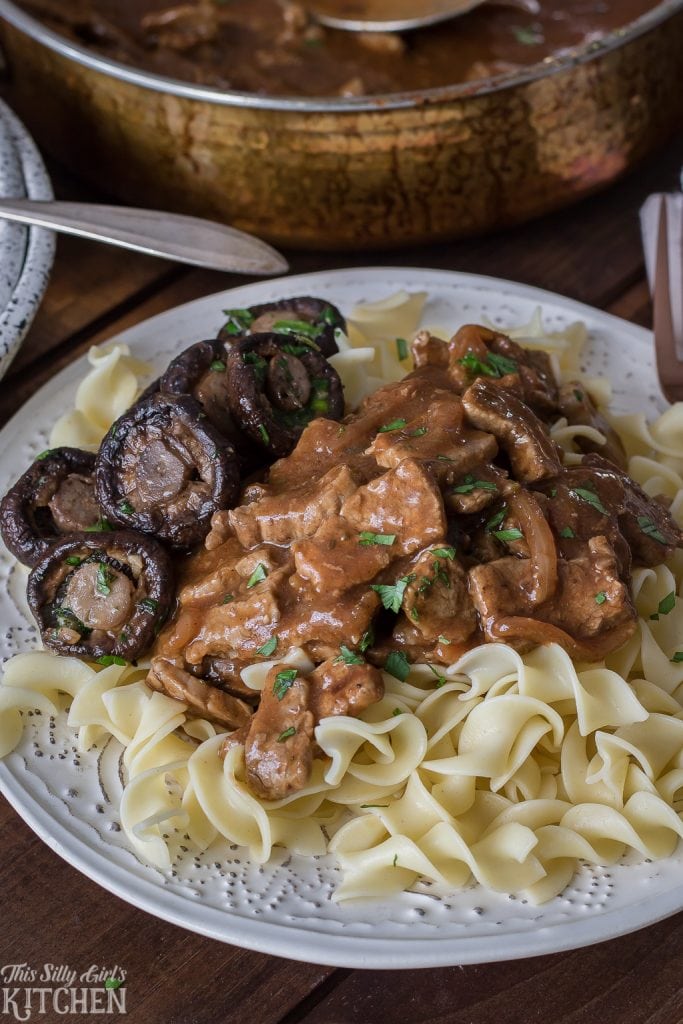 Steakhouse Beef Tips with Noodles on white plate with mushrooms