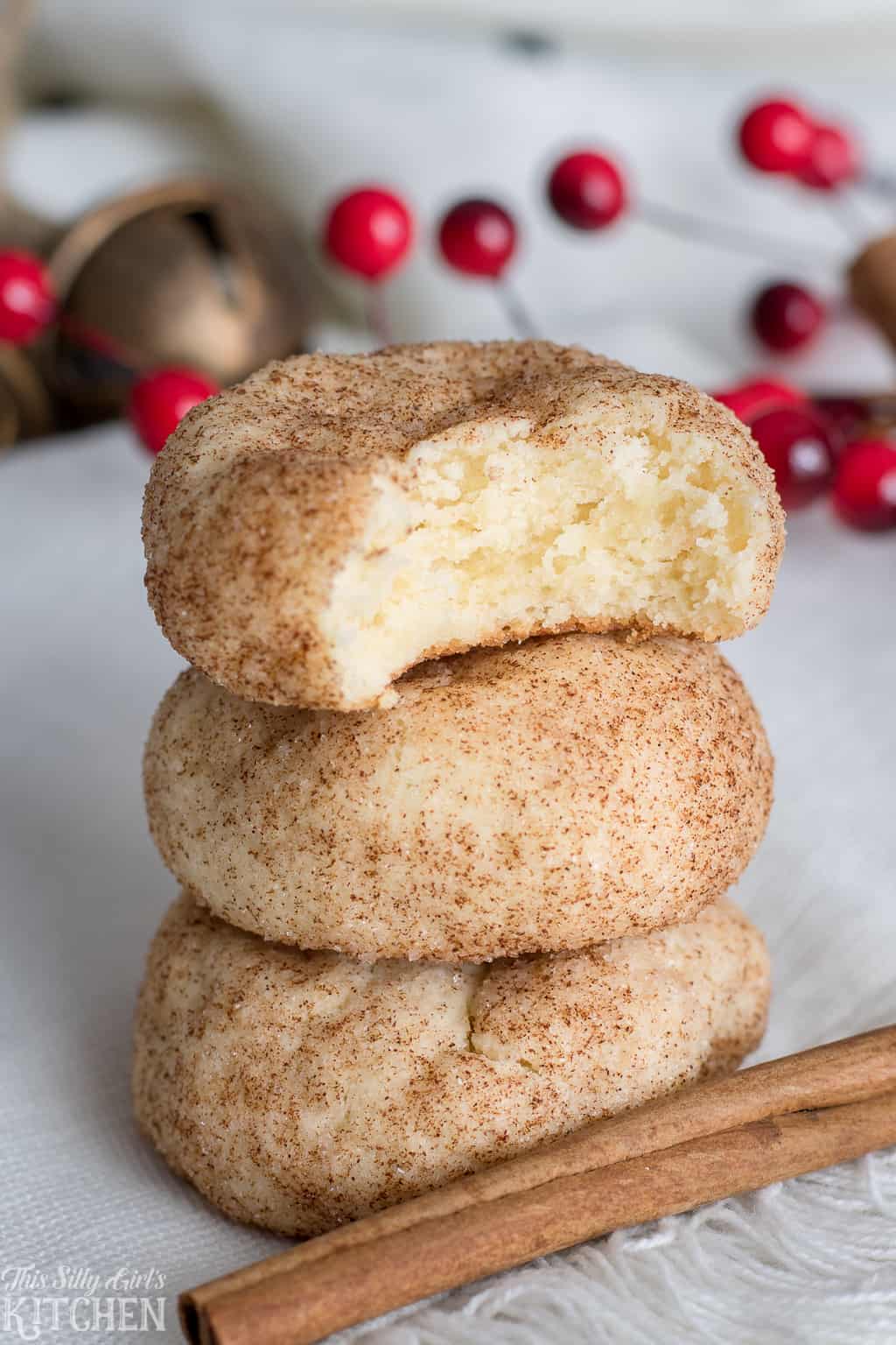 Cinnamon Cream Cheese Cookies stacked with bite taken out of top cookie