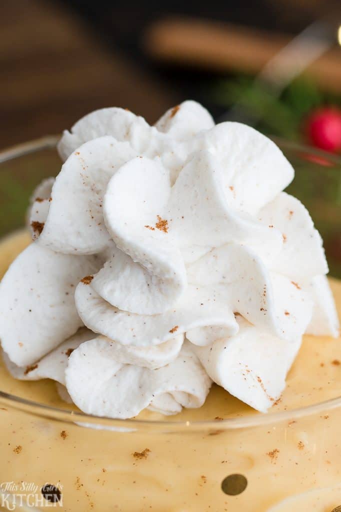 Bowl of Stabilized Whipped Cream with Cornstarch showcasing the silky pillowy texture and creamy folds.