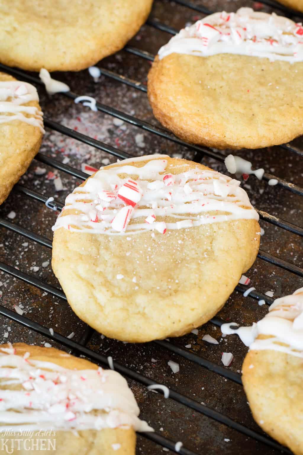 White Chocolate Peppermint Sugar Cookies, classic chewy soft sugar cookies drizzled with white chocolate and crushed peppermint! #Recipe from ThisSillyGirlsKitchen.com #sugarcookies #ChristmasCookies #peppermint #whitechocolate