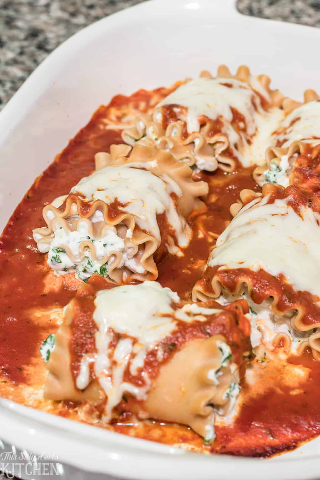 Skinny Lasagna Roll-Ups, little packages filled with ricotta cheese and sauteed kale, a lightened up recipe full of flavor! #Recipe from ThisSillyGirlsKitchen.com #lasagna #skinny #lasagnarolls
