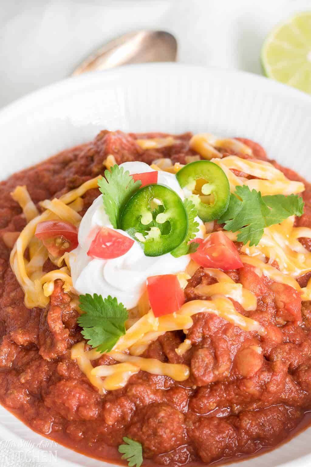 Close up of Chili with toppings in white bowl