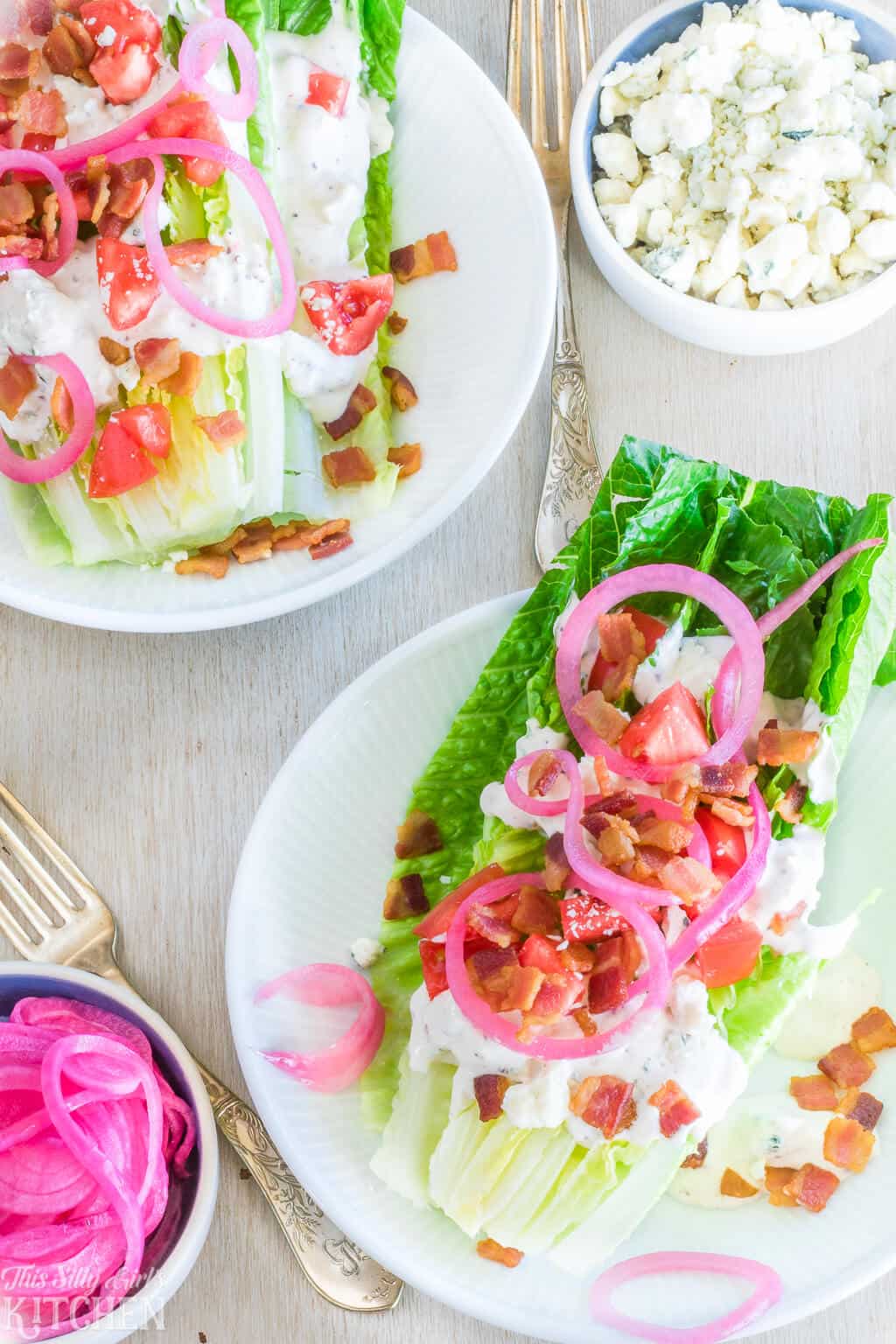 Two Wedge Salads on white plates overhead