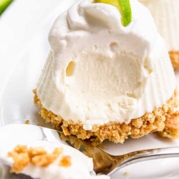 Mini No Bake Key Lime Pie on a plate topped with whipped cream and a key lime slice.