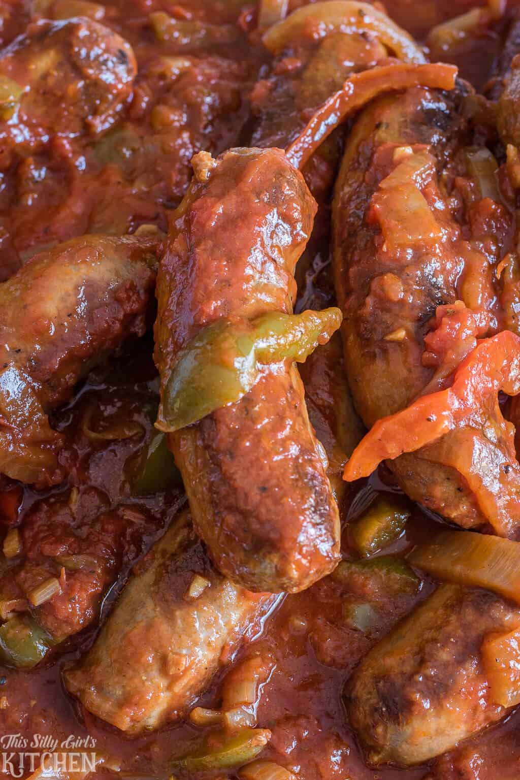 Close up of dish showing cooked sausage and peppers.