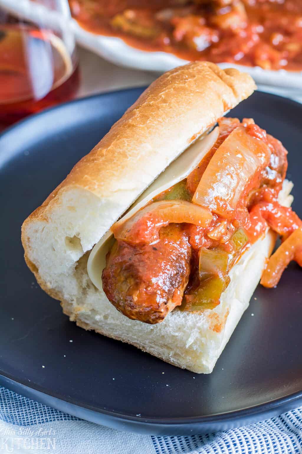 Sausage and Peppers on bun with cheese.