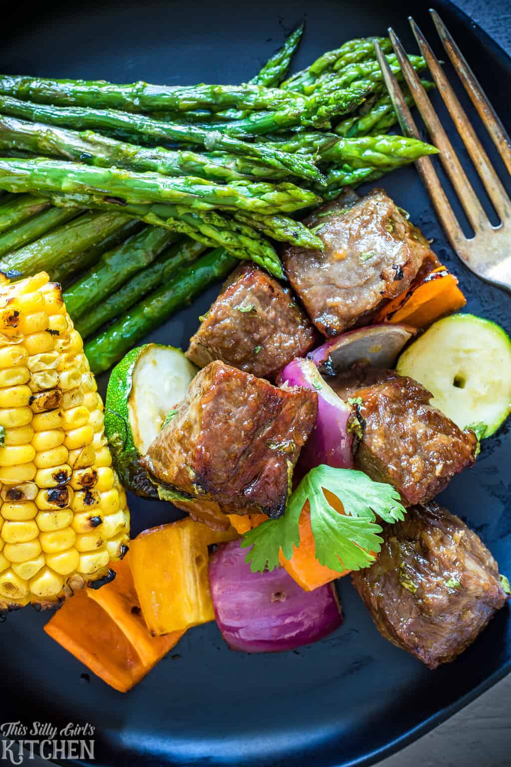 Close of Steak Kabob Recipe plated with corn and asparagus
