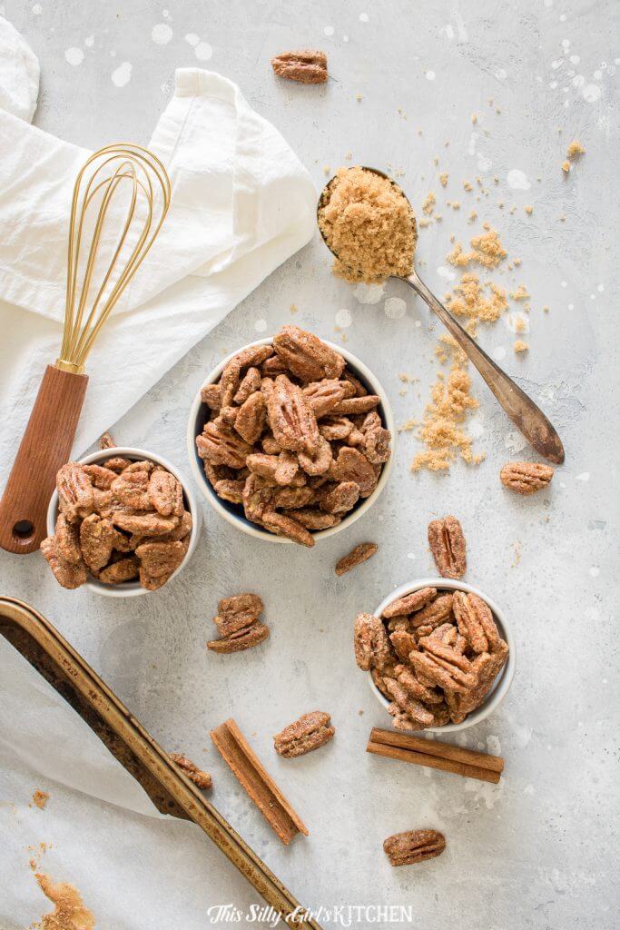Mini cuts of pecans with whisk and spoon of brown sugar