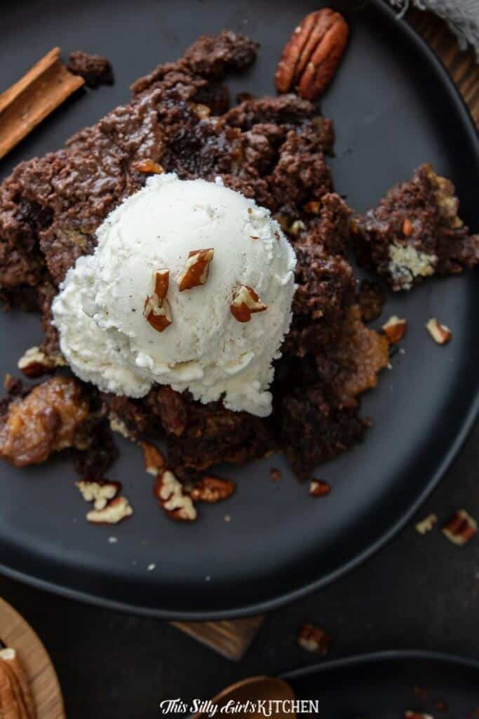 Close up overhead of Pecan Cobbler with ice cream and chopped up pecans