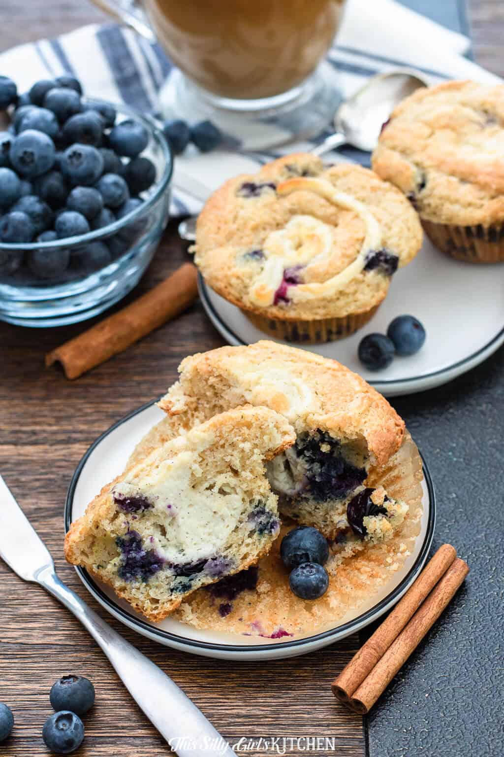 Best Blueberry Muffins on plate open showing cream cheese filling.