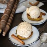 Baked Apples in a cast iron skillet filled with melted brown sugar cinnamon butter.