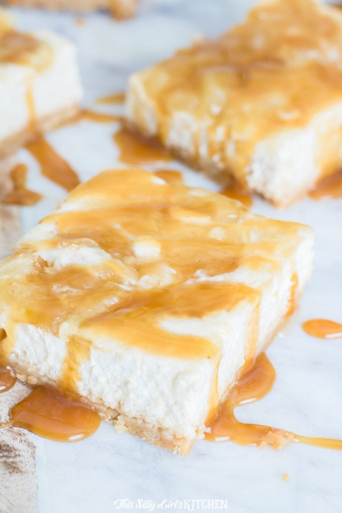 Close up of sliced Caramel Apple Cheesecake Bar drizzled with caramel