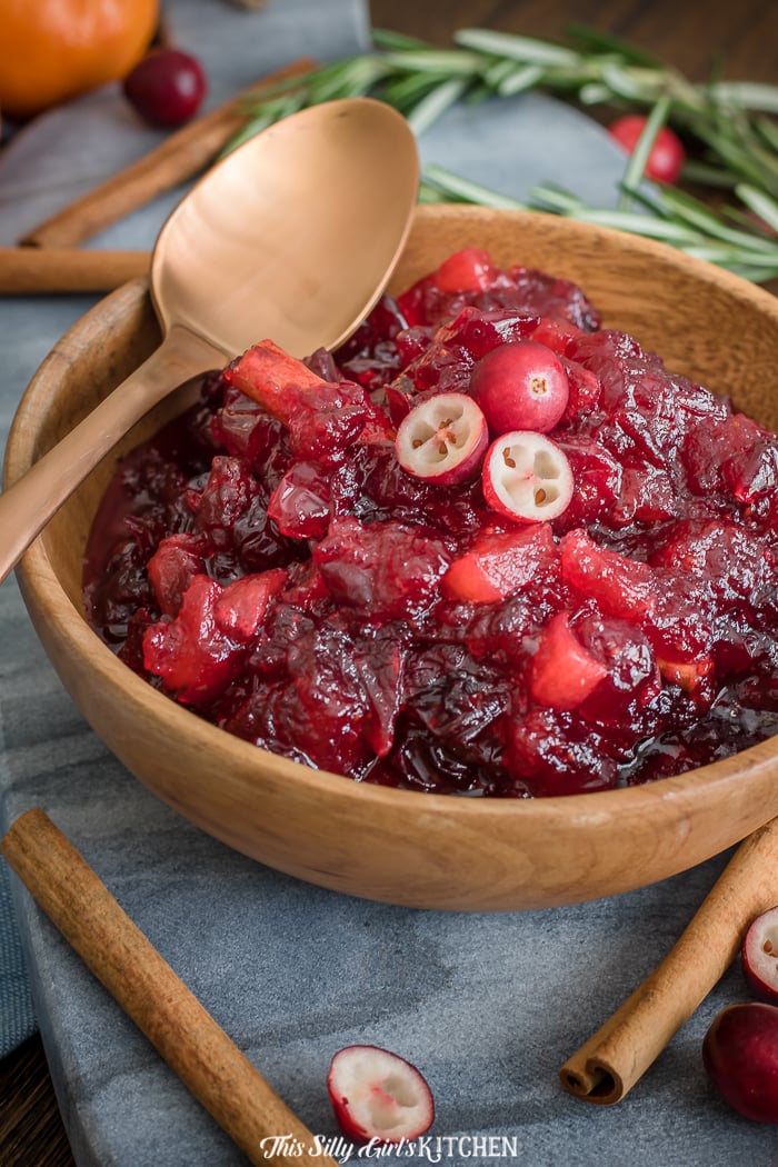 Apple Cranberry Sauce in wooden bowl with gold spoon