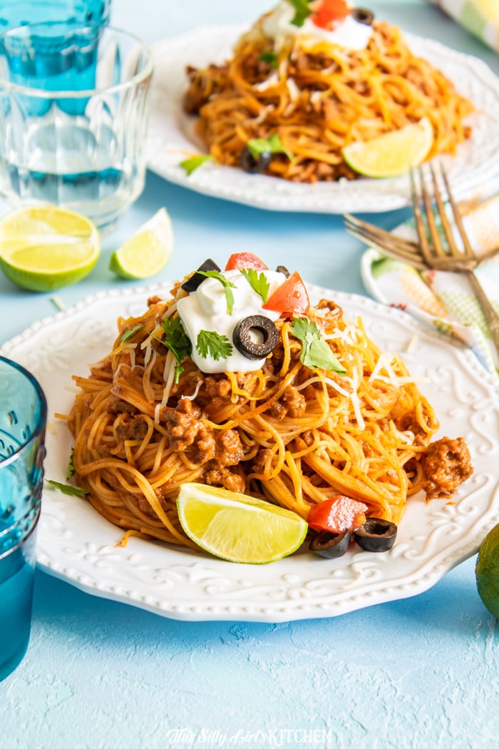 White plate with Taco Pasta dressed with toppings
