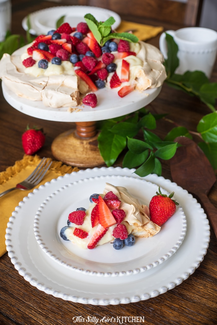 Slice cut out of full Pavlova and placed on white plate