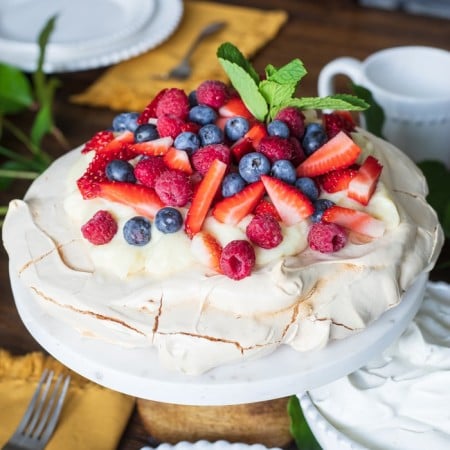 Berry Pavlova recipe on cake stand square image