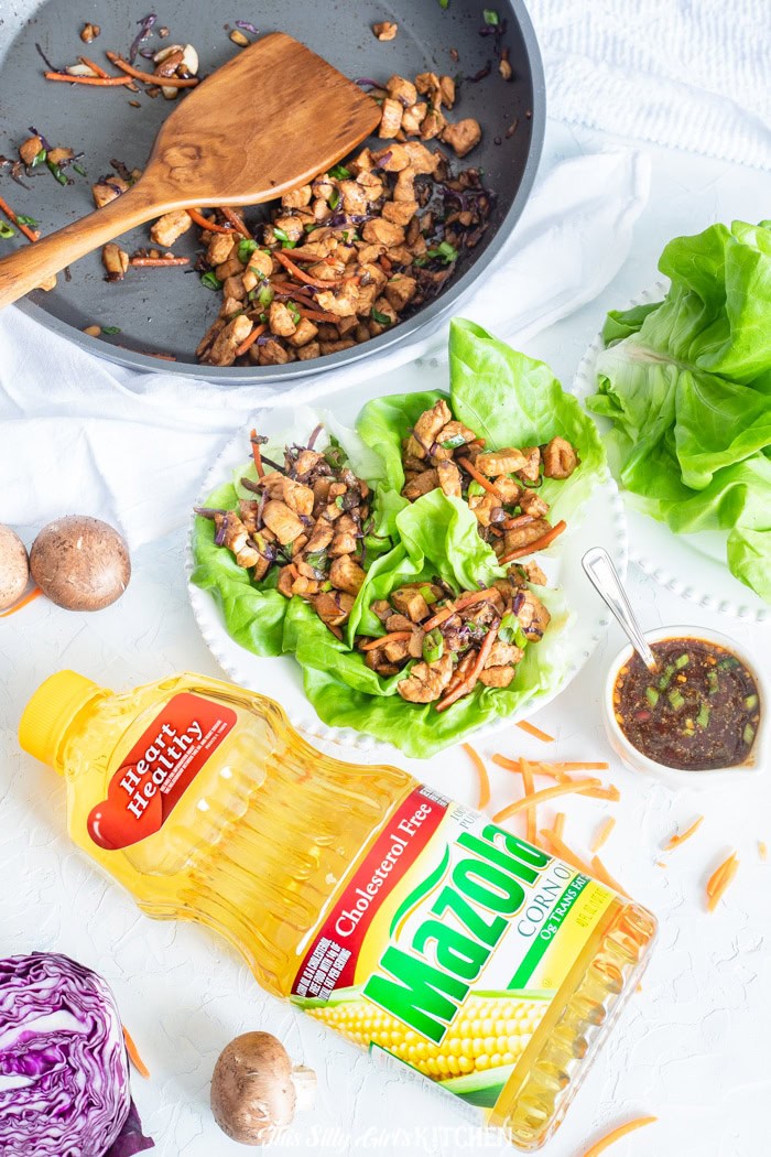 Chicken Lettuce Wrap filling cooking in a skillet with carrots, cabbage, and water chestnuts.