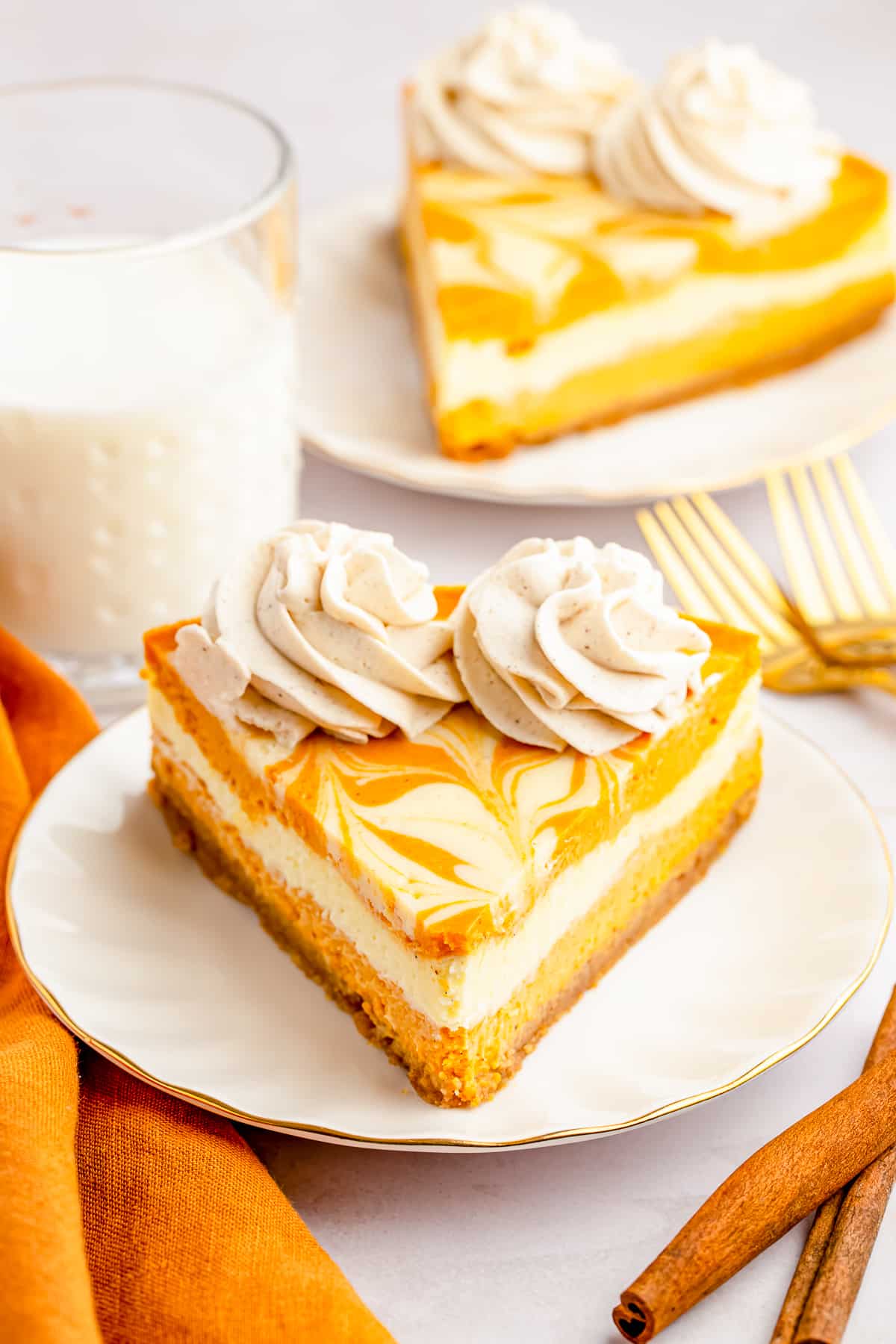 Front of Pumpkin Cheesecake showing swirls in top and whipped cream.