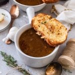 Finished French Onion Soup in white bowl with bread square image