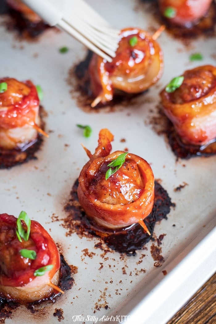 BBQ Bacon Meatball Appetizer, Flavorful meatballs wrapped in thick-cut bacon and brushed with bbq sauce then baked to crispy perfection.  #recipe from thissillygirlskitchen.com #appetizer #meatballappetizer #bacon